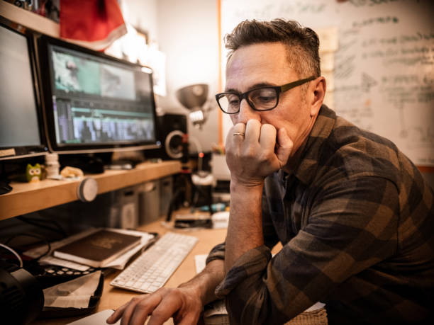 istock Male video editor working at home 1287440069