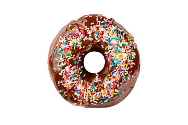 Donut covered with chocolate frosting and decorated with colored sprinkles isolated on a white background. Delicious colorful chocolate doughnut A donut covered with chocolate frosting and decorated with colored sprinkles isolated on a white background. Delicious colorful chocolate doughnut doughnut stock pictures, royalty-free photos & images