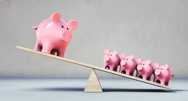 istock Piggy banks balancing on a seesaw 1287440149