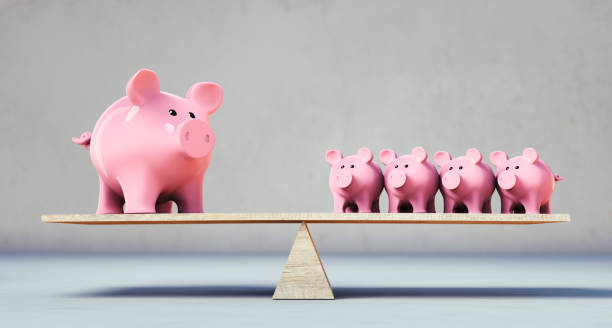 istock Piggy banks balancing on a seesaw 1287440177