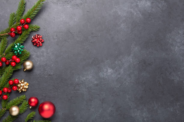 istock Christmas background with fir tree and decoration on dark stone background. Top view Copy space 1287440230
