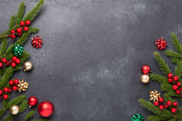 istock Christmas background with fir tree and decoration on dark stone background. Top view Copy space 1287440256