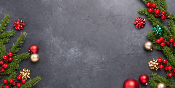 istock Christmas background with fir tree and decoration on dark stone background. Top view Copy space 1287440271