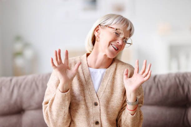 istock Cheerful mature woman laughing at home 1287440575