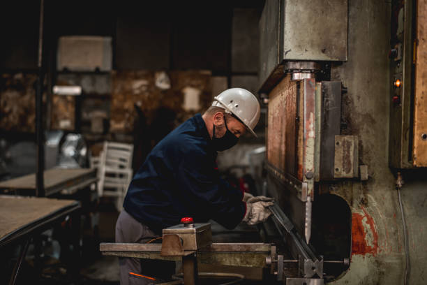istock Mature man in factory workshop working alone during epidemic 1287440742