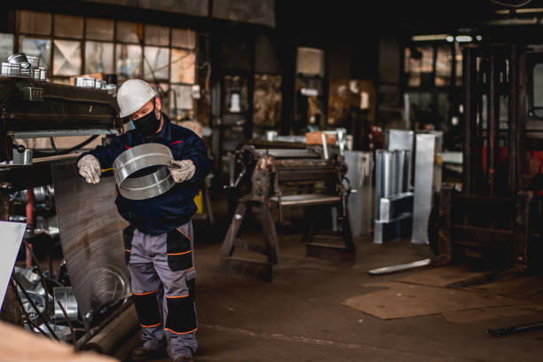 istock Mature man in factory workshop working alone during epidemic 1287441512