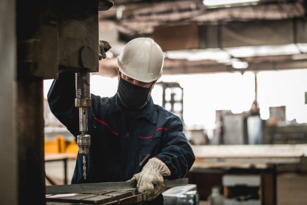 istock Mature man in factory workshop working alone during epidemic 1287442053