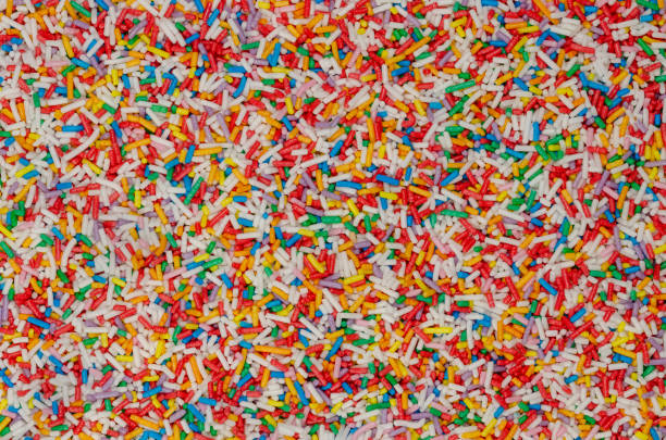 istock Rainbow sprinkles, colorful sugar sprinkles, background and surface 1287443382