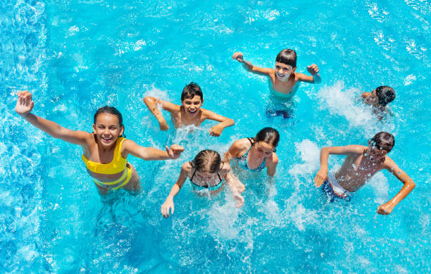 istock Many children jump and splash in swimming pool 1287445180