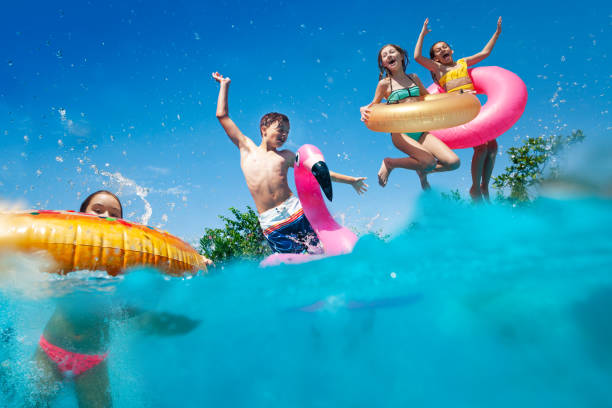 istock Half underwater split image of kids dive to pool 1287445217