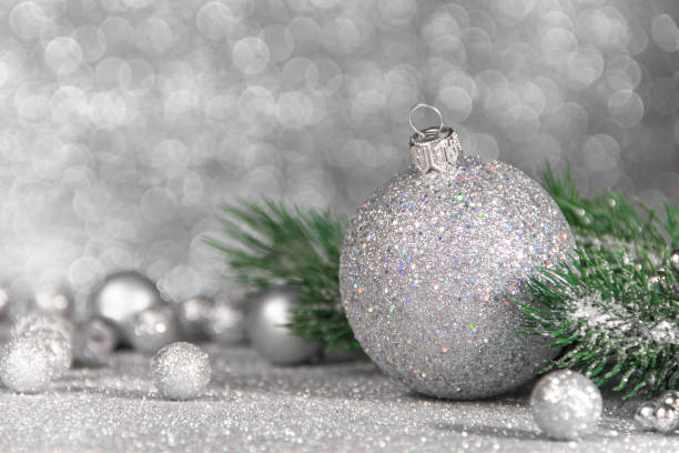 istock Silver christmas ball on glitter background. studio shot 1287448473