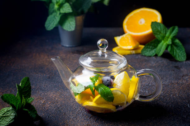 istock Fruit Tea with orange and lemon Slice, berry, Mint and Honey in teapot 1287448516