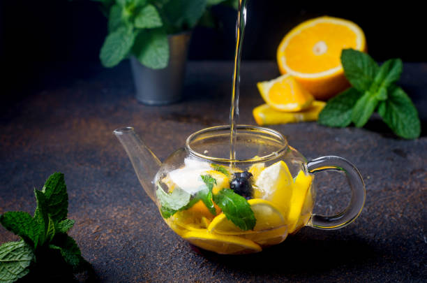 istock Fruit Tea with orange and lemon Slice, berry, Mint and Honey in teapot 1287448521