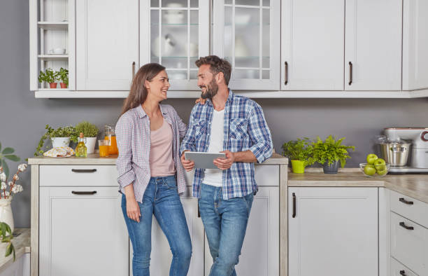 istock Young couple in the kitchen with digital tablet 1287449269