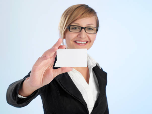 cheerful woman with business card - glasses holding business card imagens e fotografias de stock