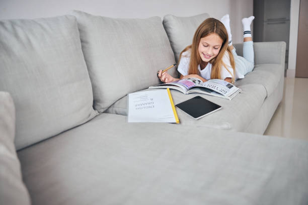 istock Minor studying with her feet in the air 1287450674
