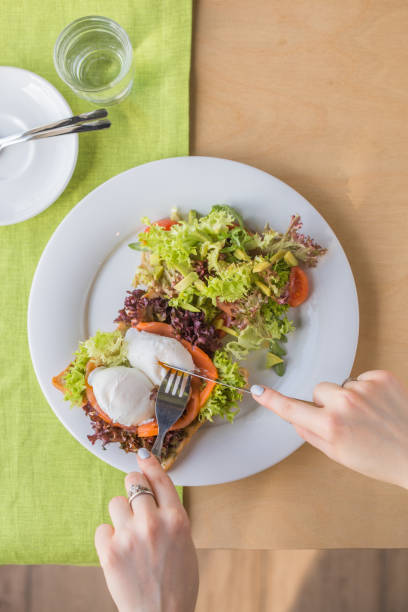 istock Pashot egg and salad with backed duck rucola cherry tomatoes mozzarella and corn. Shallow dof. 1287453157