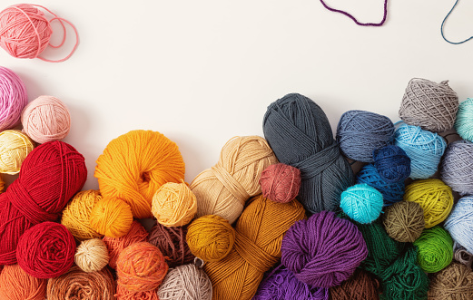 Balls of wool in various colors, on white background