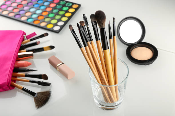 istock set of makeup brushes top view on white background. 1287454972