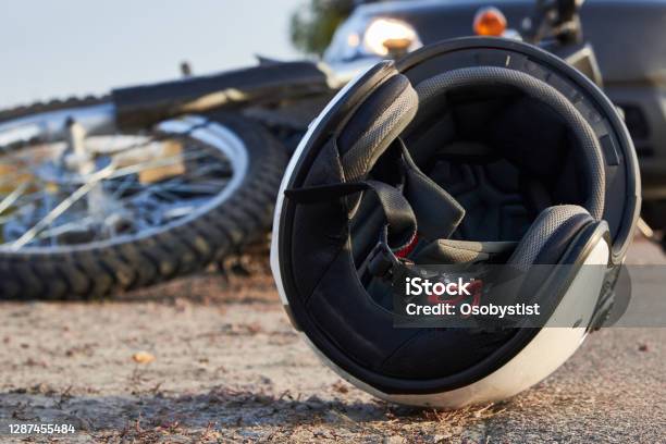 Photo Of Car Helmet And Motorcycle On The Road The Concept Of Road Accidents Stock Photo - Download Image Now