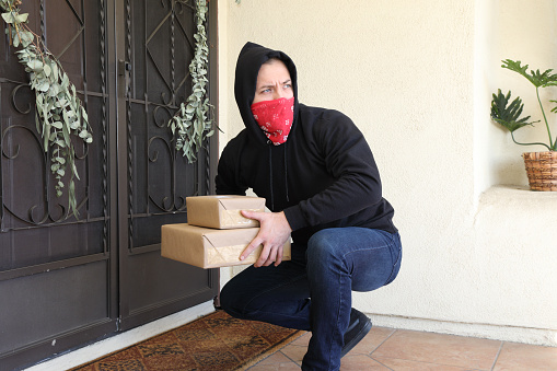 Man steals packages off porch.  Shot in Moreno Valley, California in November of 2020.