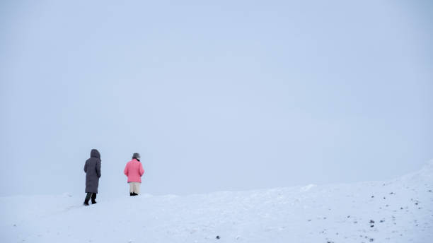 istock couple walk on white snow in winter 1287457020
