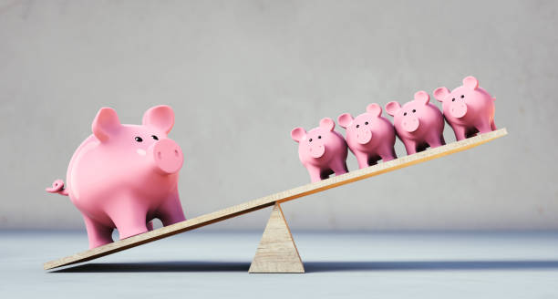 istock Piggy banks balancing on a seesaw 1287457132
