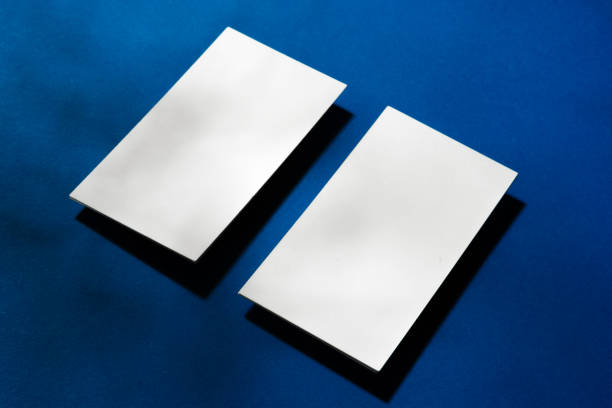 istock Two stacks of blank businesscards on blue background 1287457963