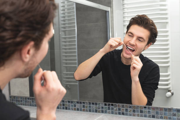 istock Man using dental floss. Dental health concept 1287464020
