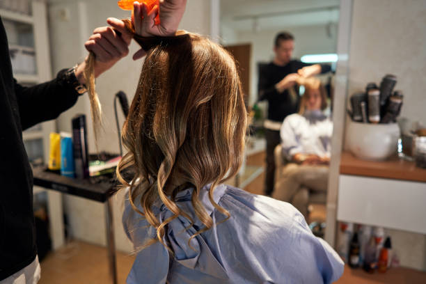 istock Professional hairdresser using hair comb to make customer locks much thicker 1287464105