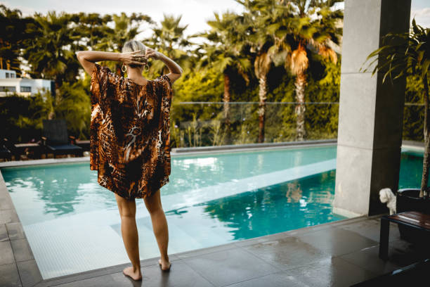 istock woman enjoying luxury pool 1287465195