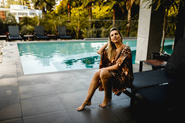 istock Woman enjoying luxury pool 1287465208