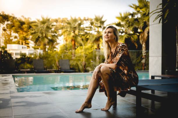 женщина наслаждаясь роскошный бассейн - luxury vacations swimming pool lifestyles стоковые фото и изображения