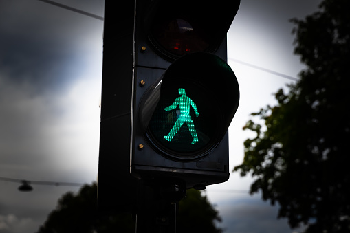 Green man walking traffic light at a city crosswalk.