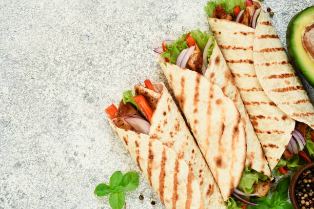 istock Grilled Mexican tortilla with vegetables on a concrete background. View from above. 1287470977