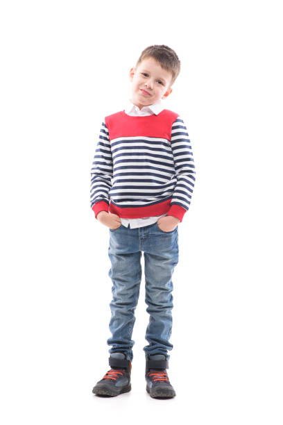 istock Smiling young cute boy child with hands in pockets looking at camera. 1287471513
