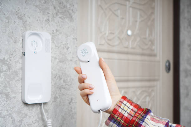 istock Woman holds the intercom receiver in the hand 1287472795