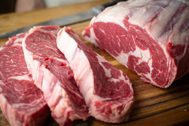 geschnittenes stück rippenauge für dick geschnittenes steak - butchers block stock-fotos und bilder