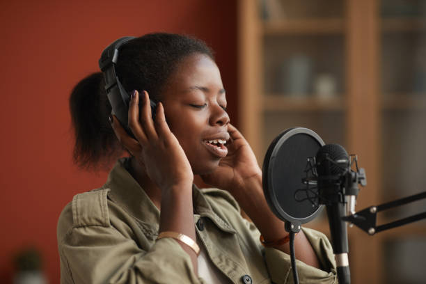 istock Talented African-American Woman Singing in Recording Studio 1287472856