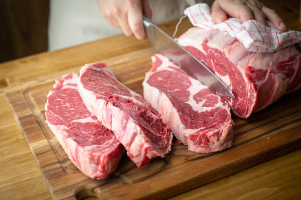 istock butcher slicing chunk of beef rib eye 1287472898