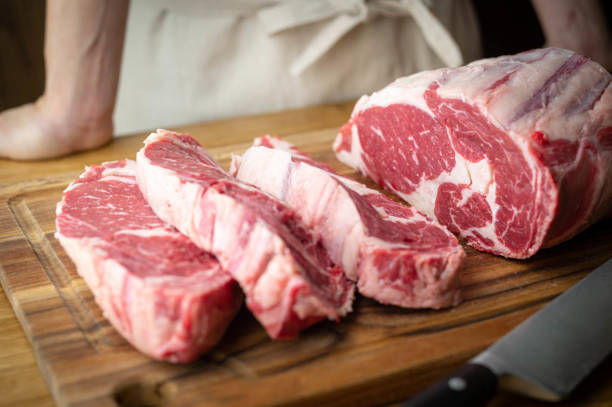 istock butcher slicing chunk of beef rib eye 1287472922