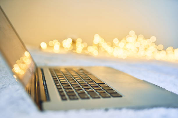 Laptop keyboard and screen glowing, working on business document at night.