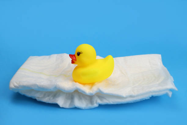 istock rubber duckling on a baby diaper on a blue background 1287477082