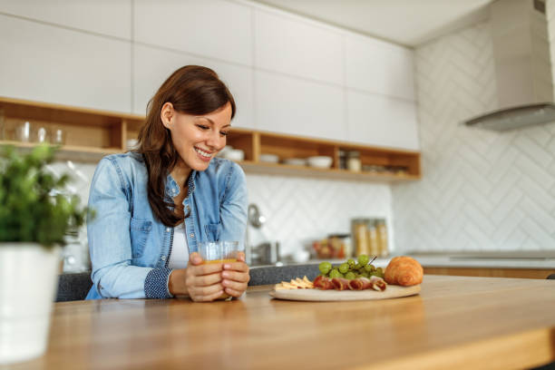 istock Holding orange juice with her hands. 1287478082