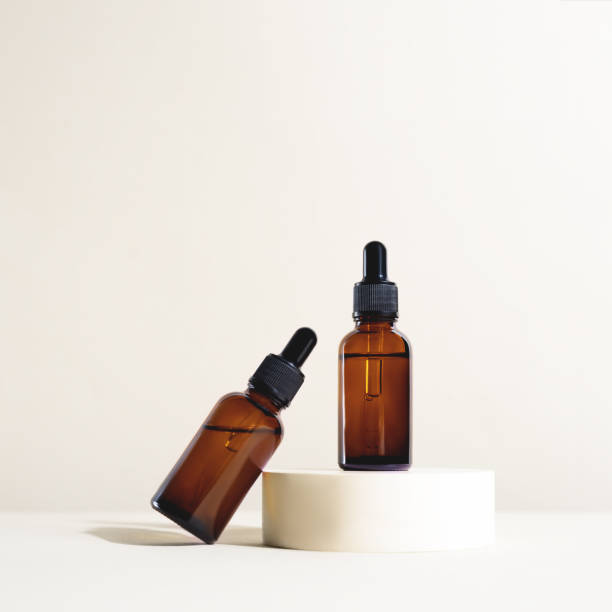 istock Glass dropper bottles on the bright background. 1287479256