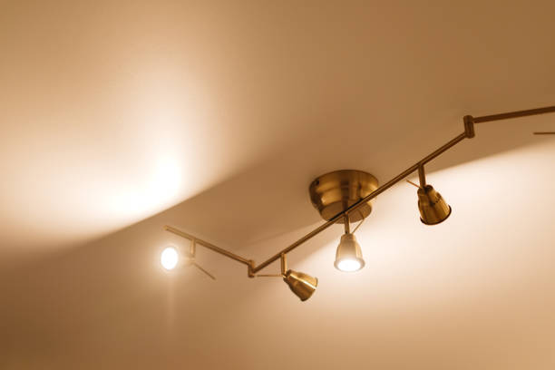 Glowing golden chandelier on the white ceiling.