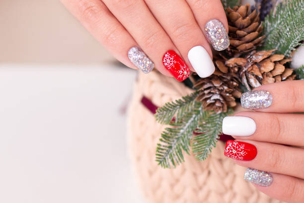 istock Female hands with winter manicure nails 1287481044