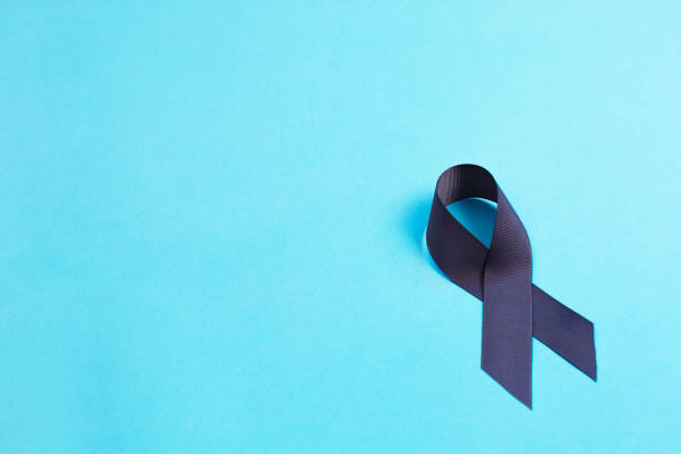 istock Brain cancer grey color awareness ribbon isolated on blue background 1287481990