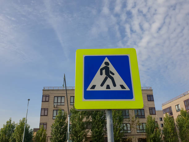 istock Road Sign Pedestrian Crosswalk Against a Blue cloudy Sky 1287483409