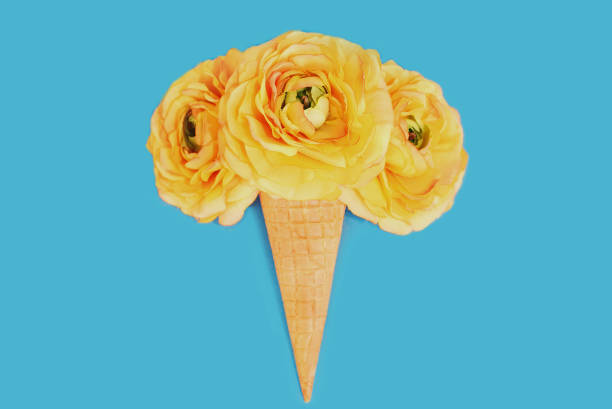 istock Cone with pink flowers as ice cream over a blue background 1287487836